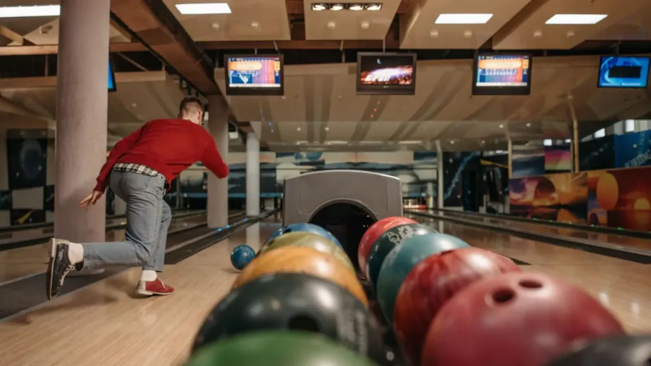 Joueur lançant une boule sur une piste de bowling